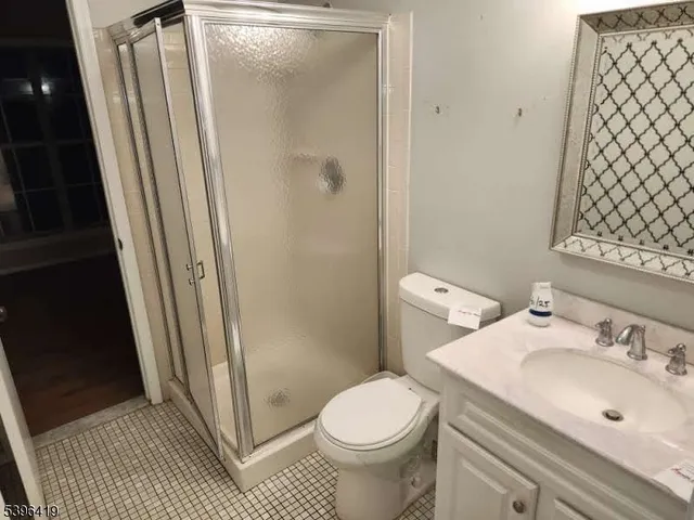a bathroom with a sink a toilet a shower and a mirror