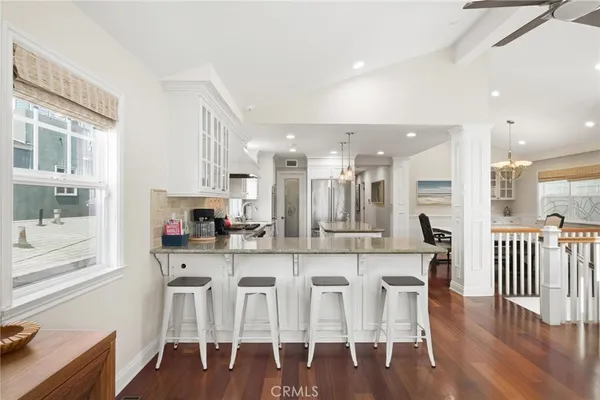 a large kitchen with a large kitchen island lots of counter space and stainless steel appliances