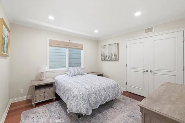 a bedroom with a bed and a dresser