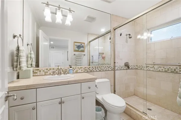 a bedroom with a bed couch and window