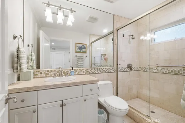 a bedroom with a bed couch and window