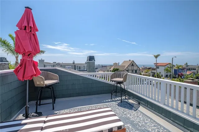 a front view of a house with a yard and mountain