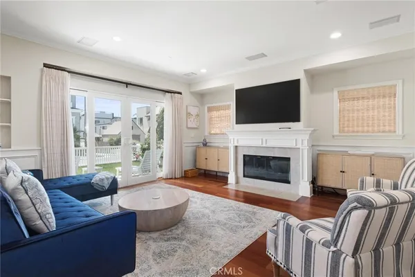 a living room with furniture and a floor to ceiling window