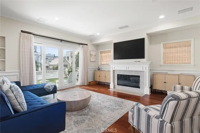 a living room with furniture and a floor to ceiling window