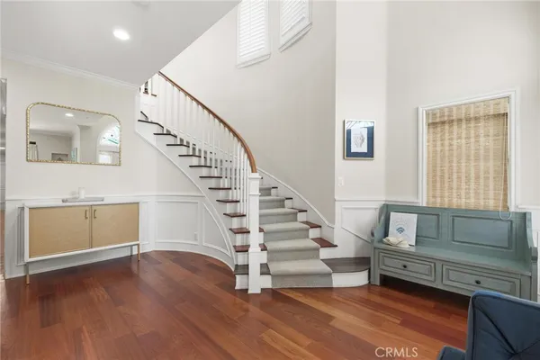 a kitchen with a refrigerator and a wooden floor