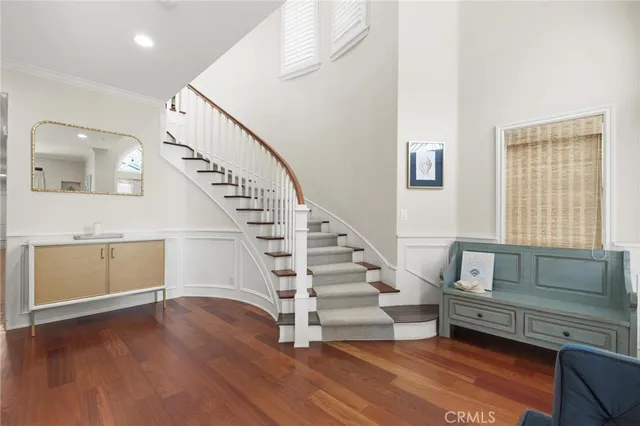 a kitchen with a refrigerator and a wooden floor