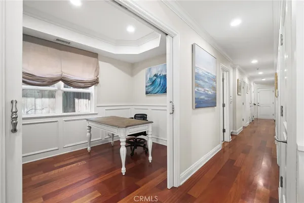 a view of a workspace with furniture and wooden floor