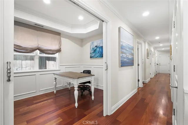 a view of a workspace with furniture and wooden floor