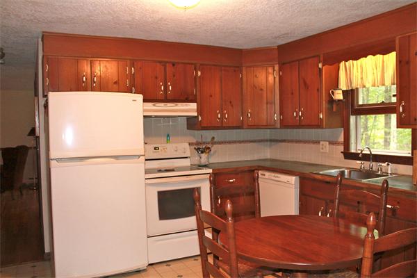 567 Fowler Road Northbridge, MA 01534 - Photo 9 of 22 a kitchen with stainless steel appliances a refrigerator a sink a stove a table and chairs