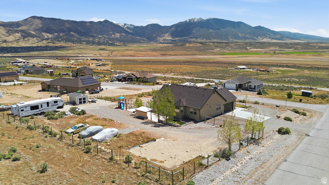 1588 West Rim Rock Drive Stockton, UT 84071 - Photo 54 of 61 Contemporary ranch-style residence featuring a dark shingle roof, solar panel installation, and an attached two-car garage
