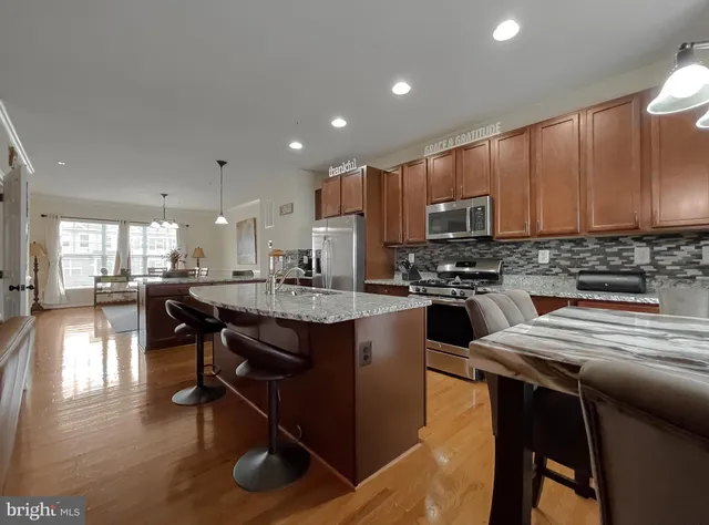 a living room with furniture and a flat screen tv with wooden floor