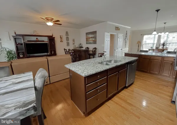 a living room with furniture and a flat screen tv with wooden floor