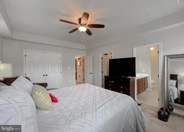a spacious bathroom with a granite countertop sink a mirror and a vanity