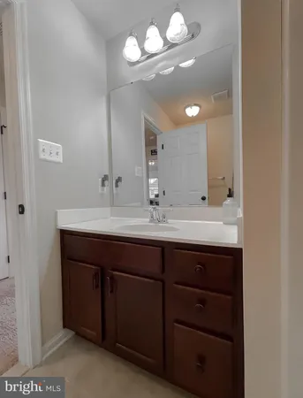 a bathroom with a toilet a sink a mirror and a shower