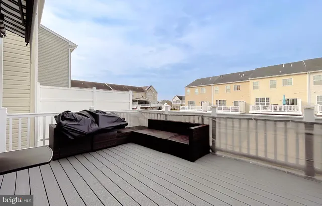 a view of a livingroom with furniture and a floor to ceiling window