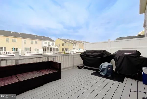 a view of a livingroom with furniture and a floor to ceiling window