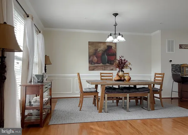 a view of a dining room with furniture and chandelier