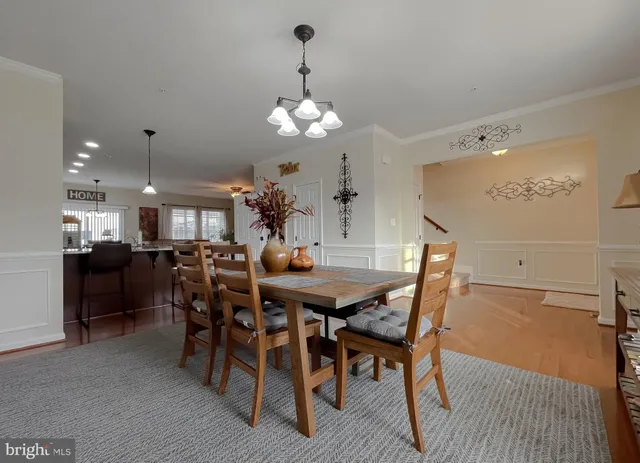 a living room with stainless steel appliances granite countertop furniture a fireplace a flat screen tv and a window