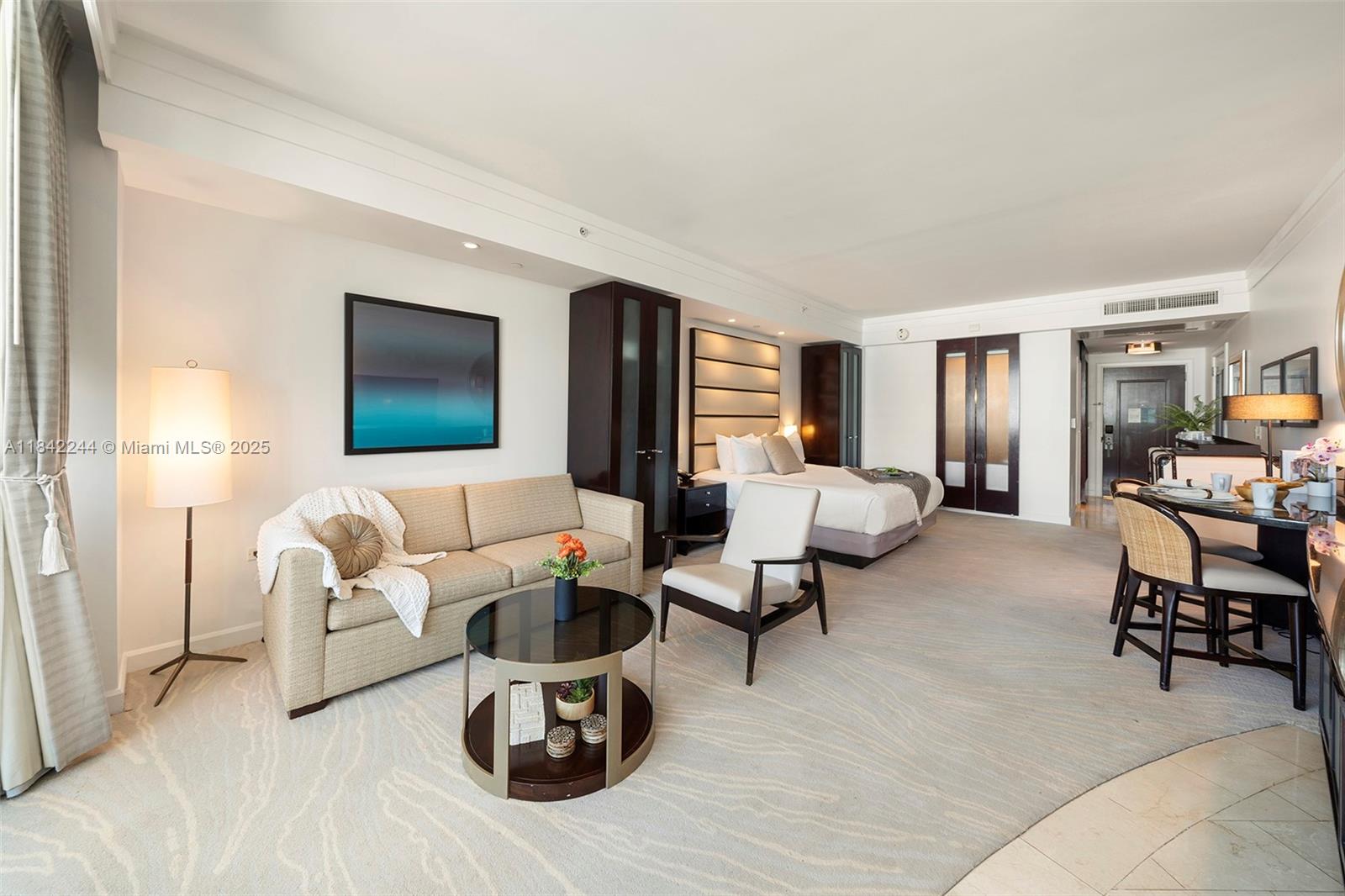 4391 Collins Avenue, Unit 802 Miami Beach, FL 33140 - Photo 11 of 39 a living room with furniture and a flat screen tv