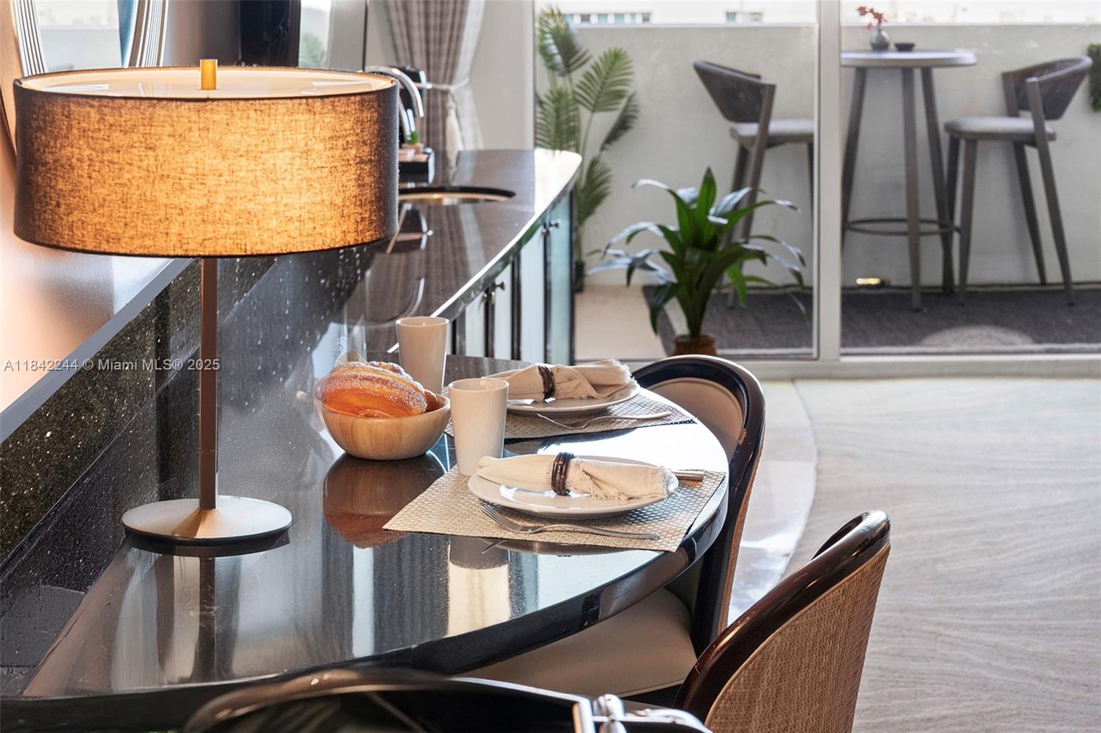 4391 Collins Avenue, Unit 802 Miami Beach, FL 33140 - Photo 14 of 39 a dining room with furniture and wooden floor