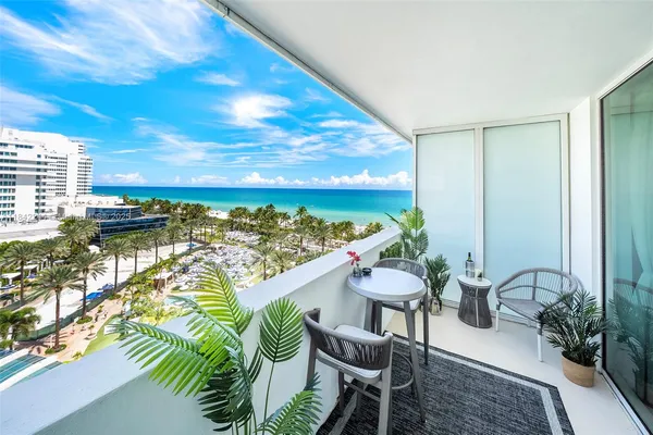a balcony with chairs and a table