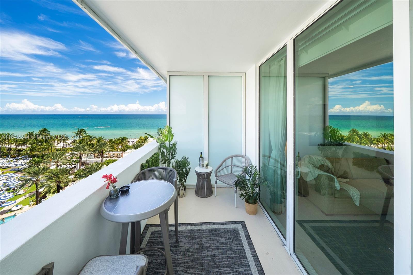 4391 Collins Avenue, Unit 802 Miami Beach, FL 33140 - Photo 26 of 39 a balcony with table and chairs