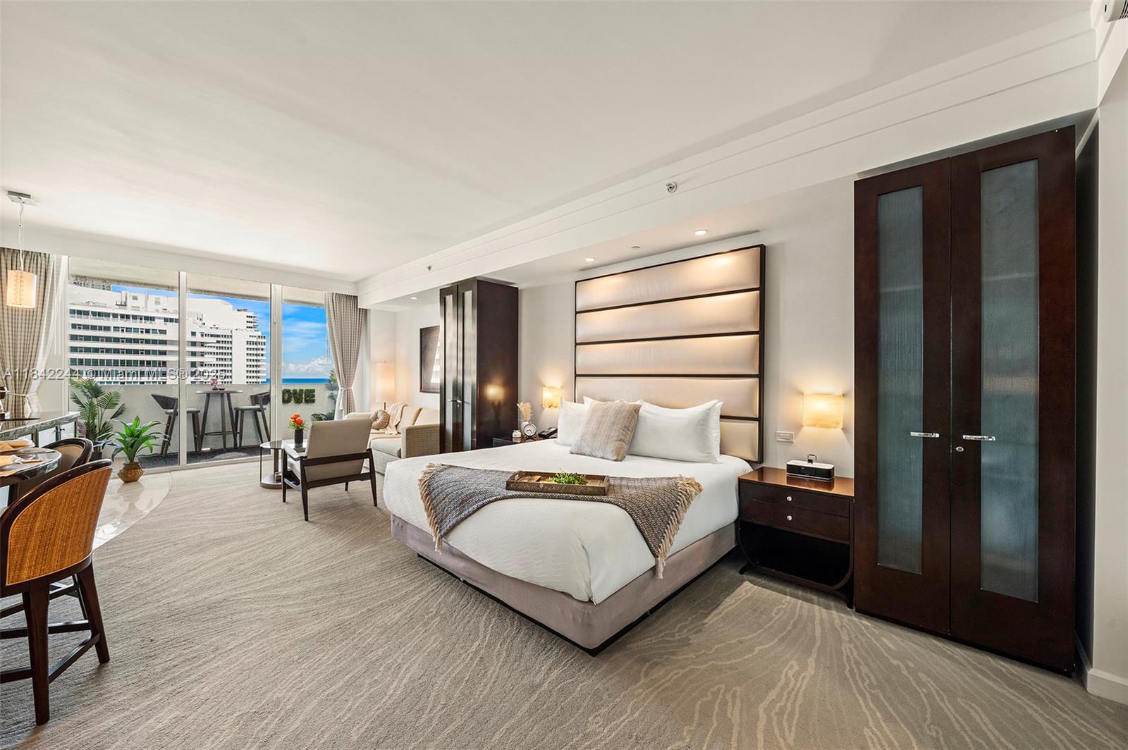 4391 Collins Avenue, Unit 802 Miami Beach, FL 33140 - Photo 27 of 39 a bedroom with a bed and wooden floor