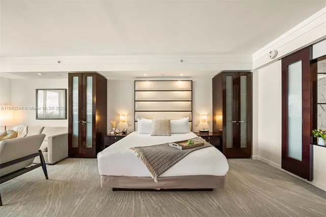 a bedroom with a large bed and a large window