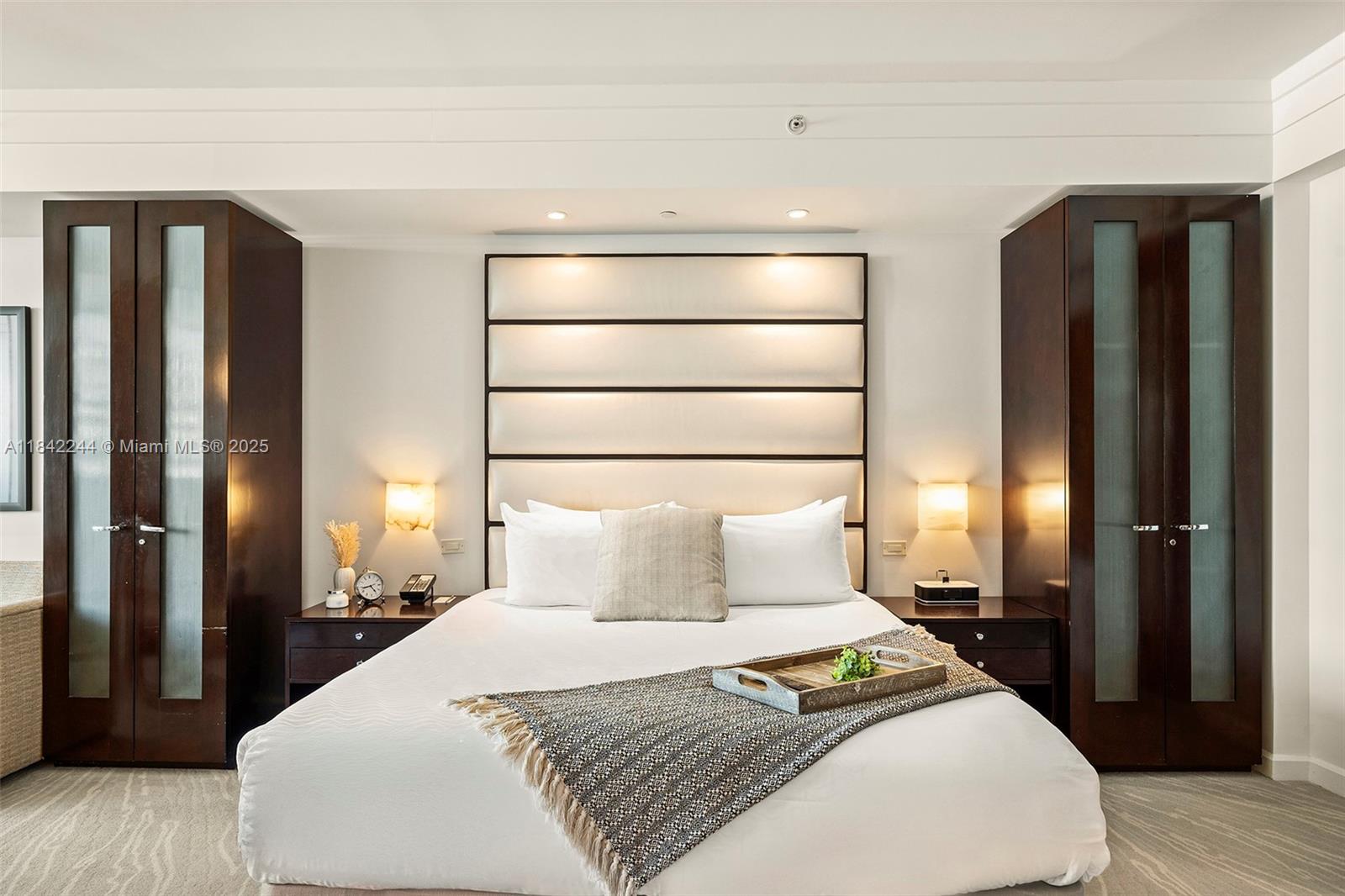 4391 Collins Avenue, Unit 802 Miami Beach, FL 33140 - Photo 30 of 39 a bedroom with a bed and wooden floor