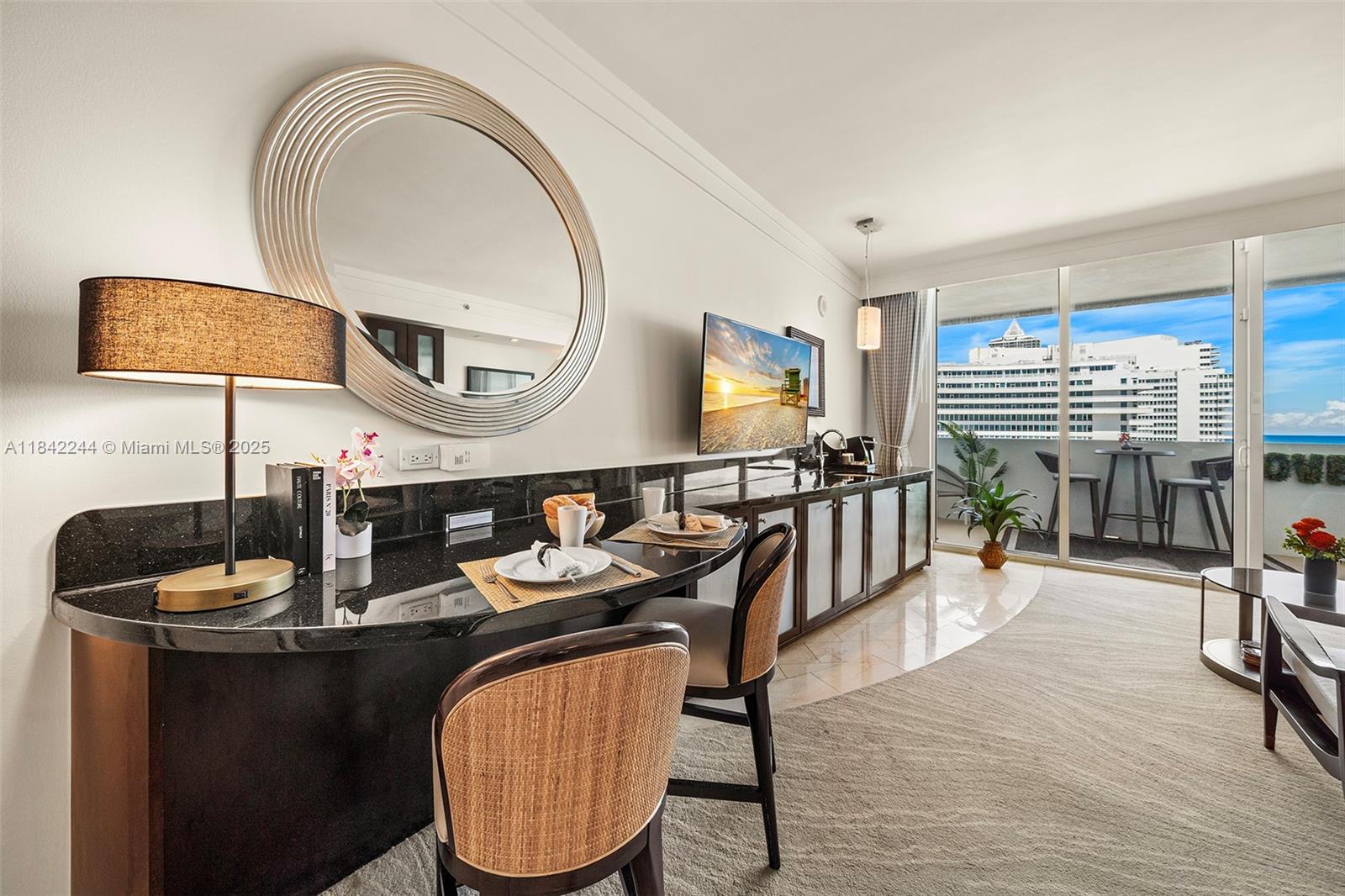 4391 Collins Avenue, Unit 802 Miami Beach, FL 33140 - Photo 3 of 39 a dining room with furniture and wooden floor