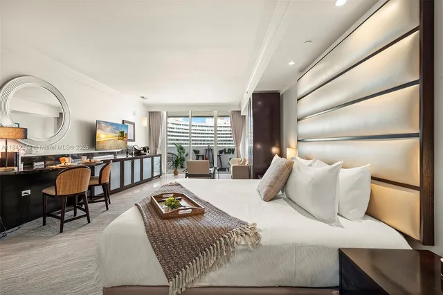 a bedroom with furniture and a window