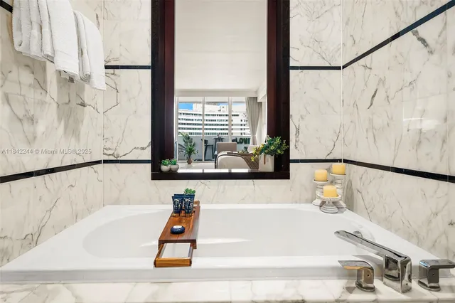 a bathroom with a bathtub and shower