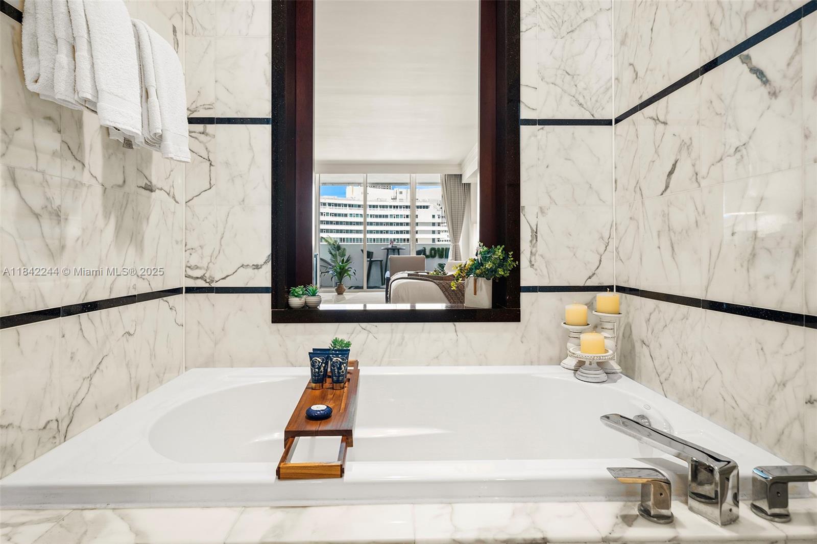 4391 Collins Avenue, Unit 802 Miami Beach, FL 33140 - Photo 34 of 39 a bathroom with a bathtub and shower