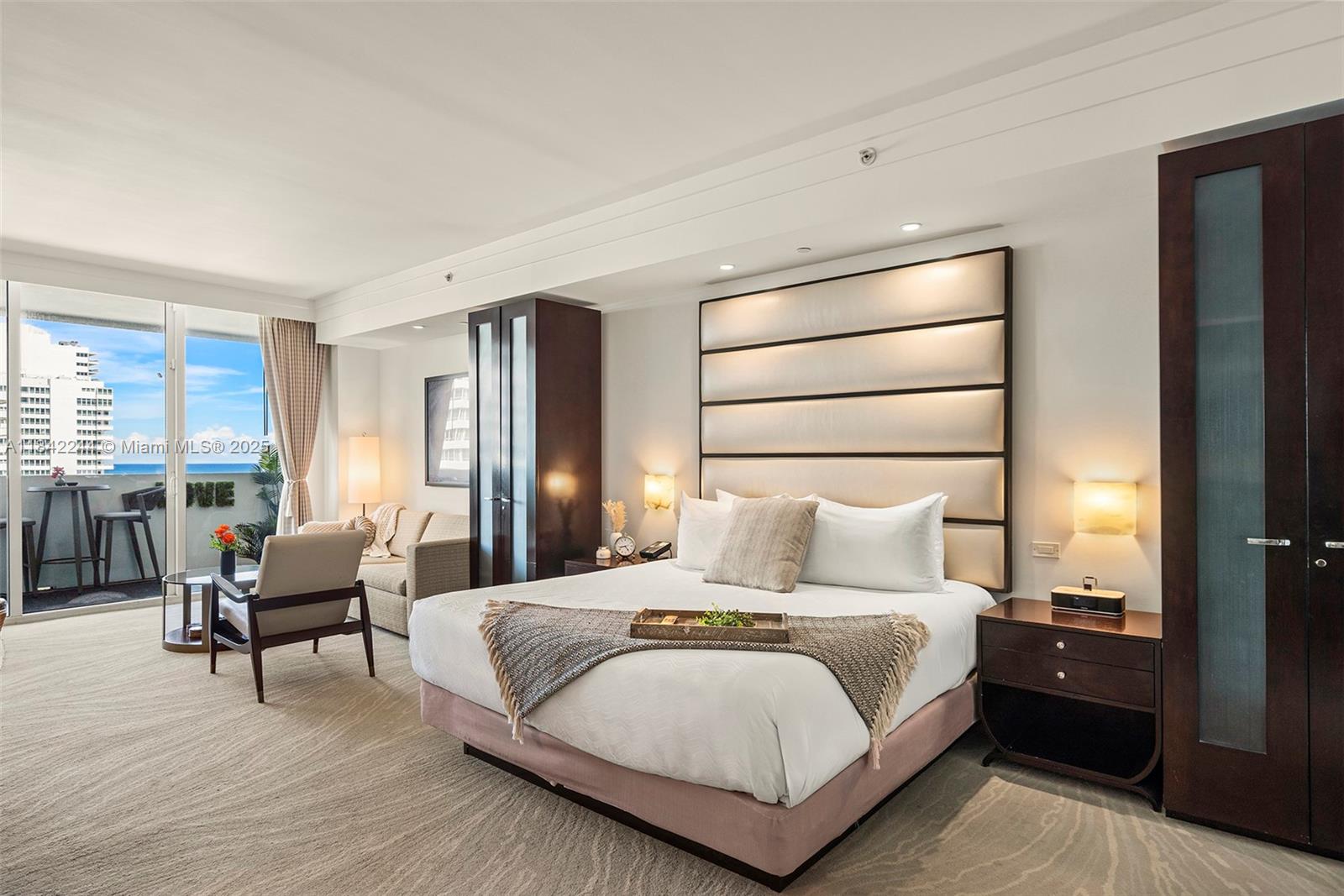 4391 Collins Avenue, Unit 802 Miami Beach, FL 33140 - Photo 5 of 39 a bedroom with a bed and wooden floor