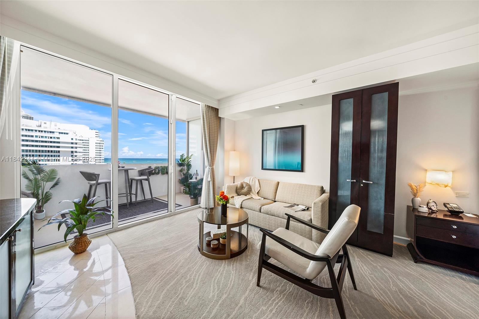 4391 Collins Avenue, Unit 802 Miami Beach, FL 33140 - Photo 7 of 39 a living room with furniture and wooden floor