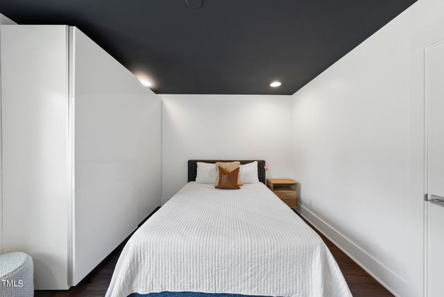 a bed room with a bed and a night stand