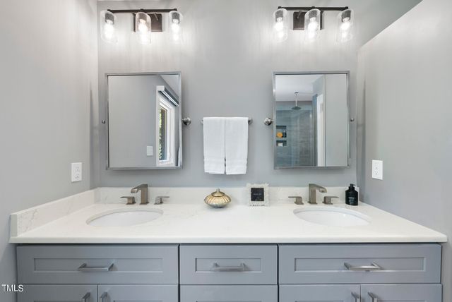 a bathroom with a sink double vanity and a mirror