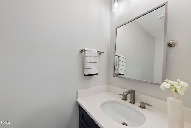 a bathroom with a sink and mirror