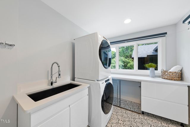 a kitchen with a sink cabinets and a window