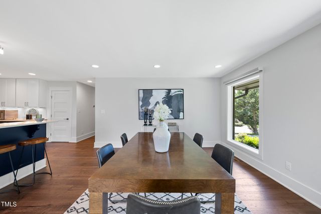 a view of a dining room with furniture and a window
