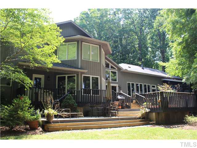 1035 Anglers Way Roxboro, NC 27574 - Photo 1 of 25 Lakefront side of home! Gorgeous outdoor living areas that include a Dining/ Lounging area, grill zone, hot tub area and covered porch as well.