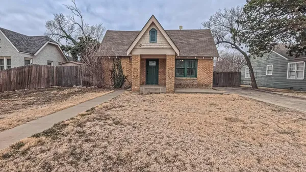 a front view of a house with a yard covered with snow