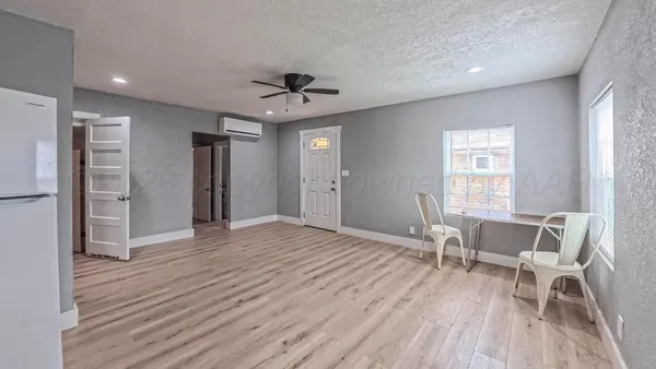 a view of a livingroom with furniture and a window