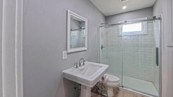 a bathroom with a sink toilet and shower
