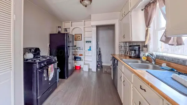 a kitchen with a sink stove and refrigerator