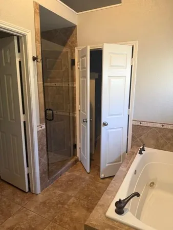 a bathroom with a tub and shower