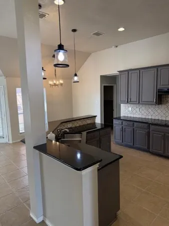 a kitchen with stainless steel appliances granite countertop a sink a stove and a refrigerator