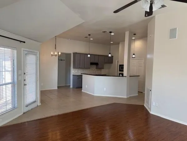a view of a kitchen with a refrigerator and a sink