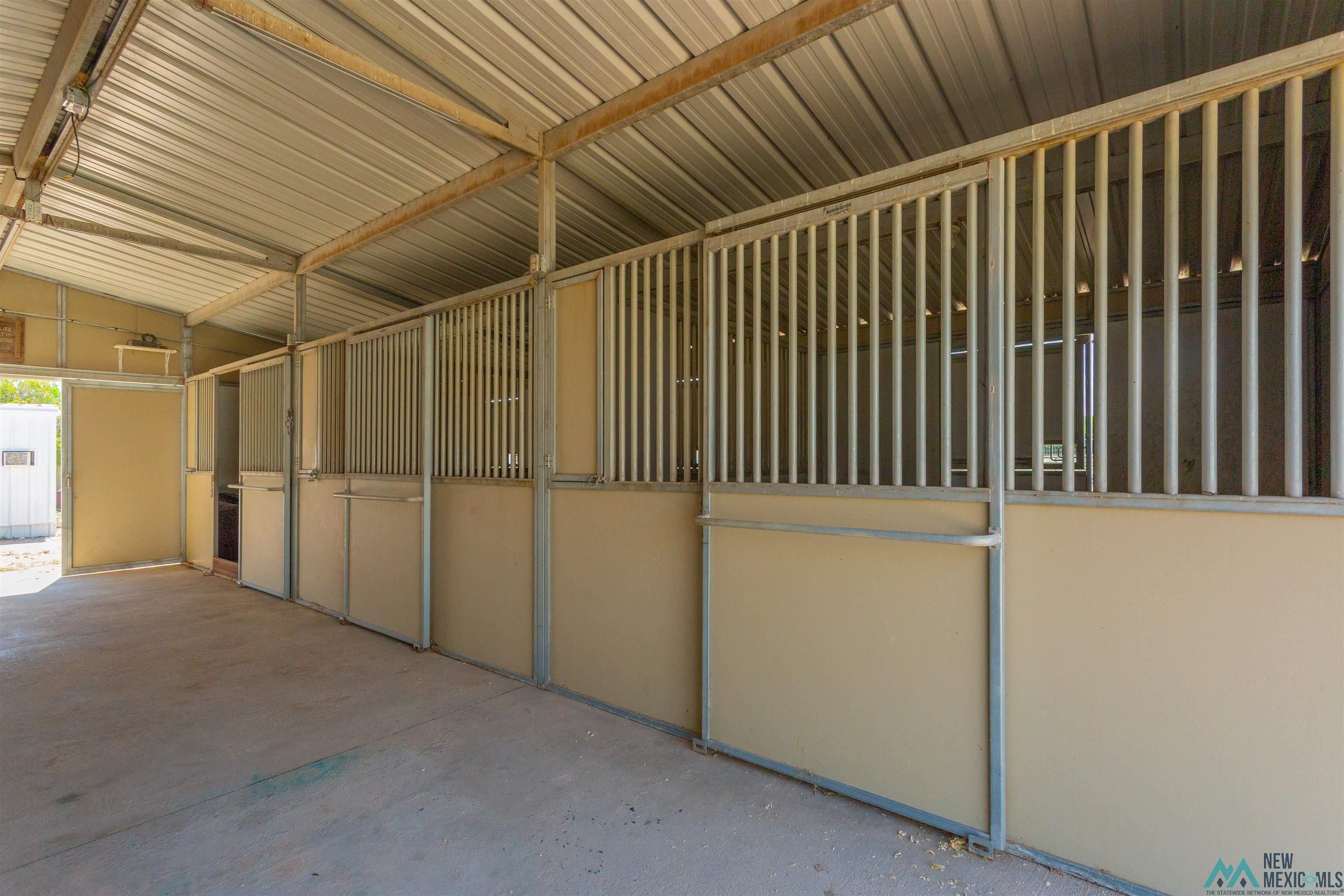 2012 South Haldeman Road Artesia, NM 88210 - Photo 68 of 96 Covered equestrian stalls featuring metal construction, concrete flooring, and an open-air design. Made by Barn Master