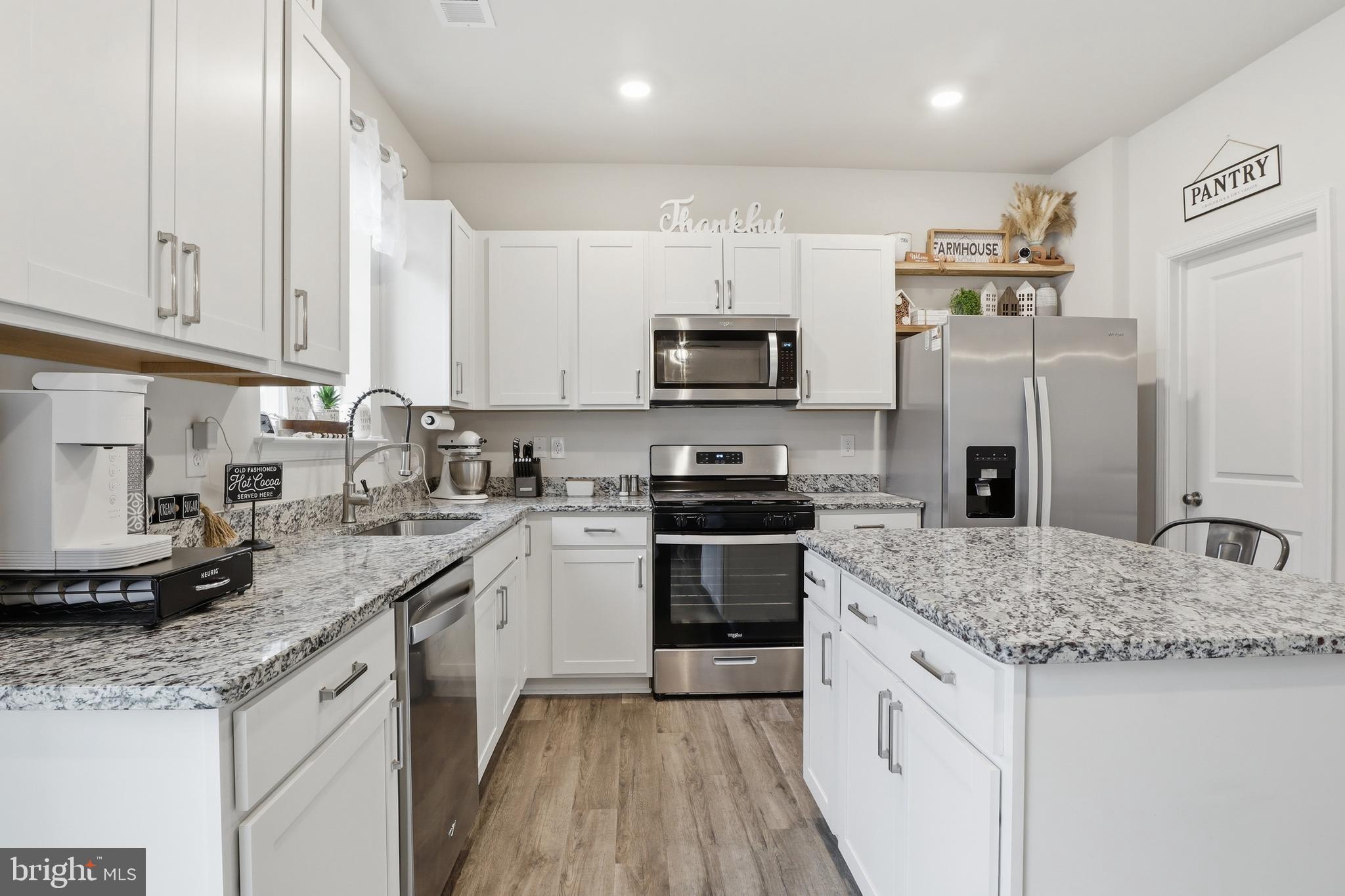 4301 Brent Drive Spring Grove, PA 17362 - Photo 11 of 49 a kitchen with stainless steel appliances granite countertop a sink stove microwave and refrigerator